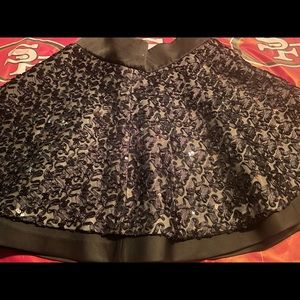 Brand new with tags. Really cute short black lace with rhinestone skirt.